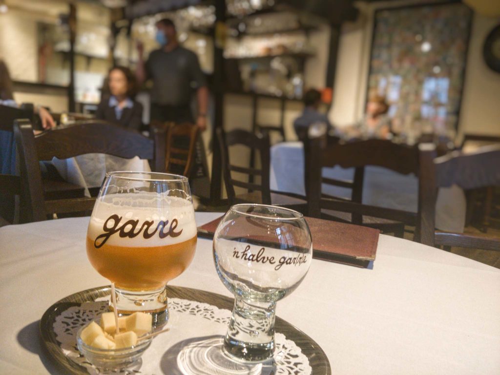 A Tripel de Garre beer from tap and small-glass version in the bar in Bruges