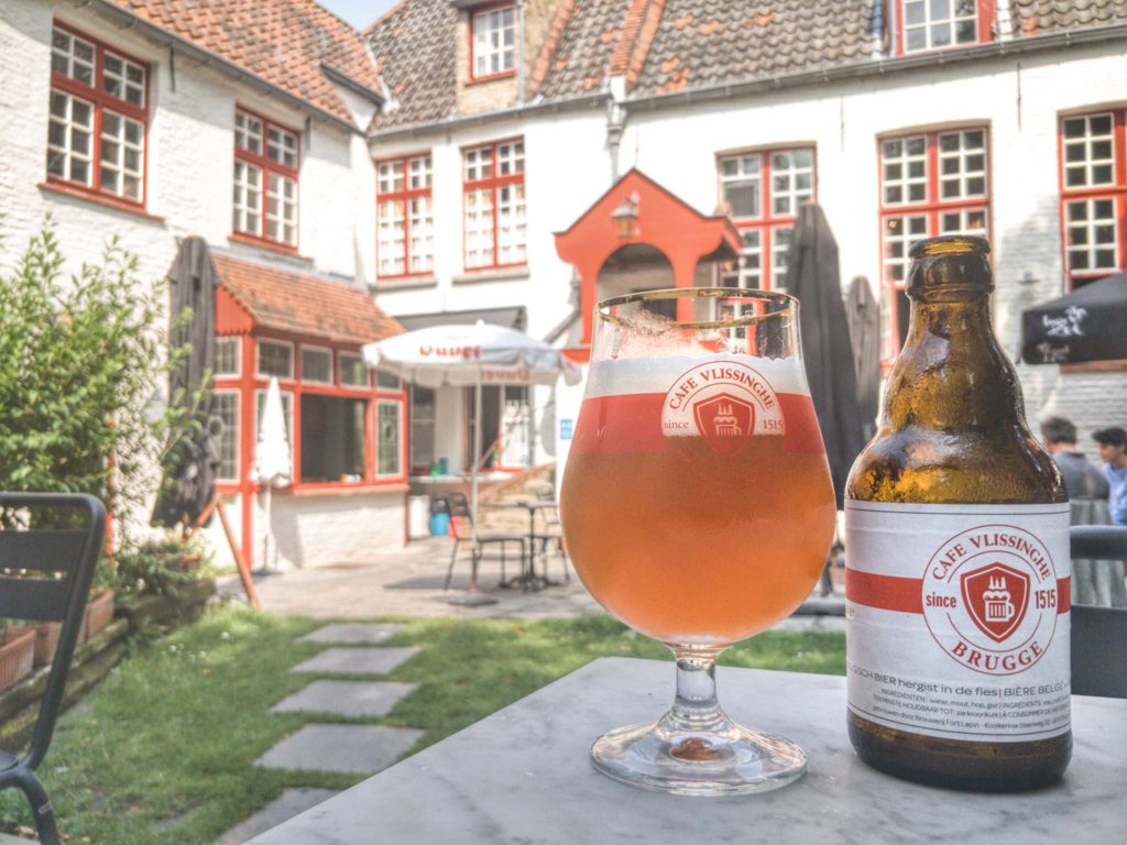 A Vlissinghe beer poured from the bottle into its matching glass on the terrace in the garden behind the bar