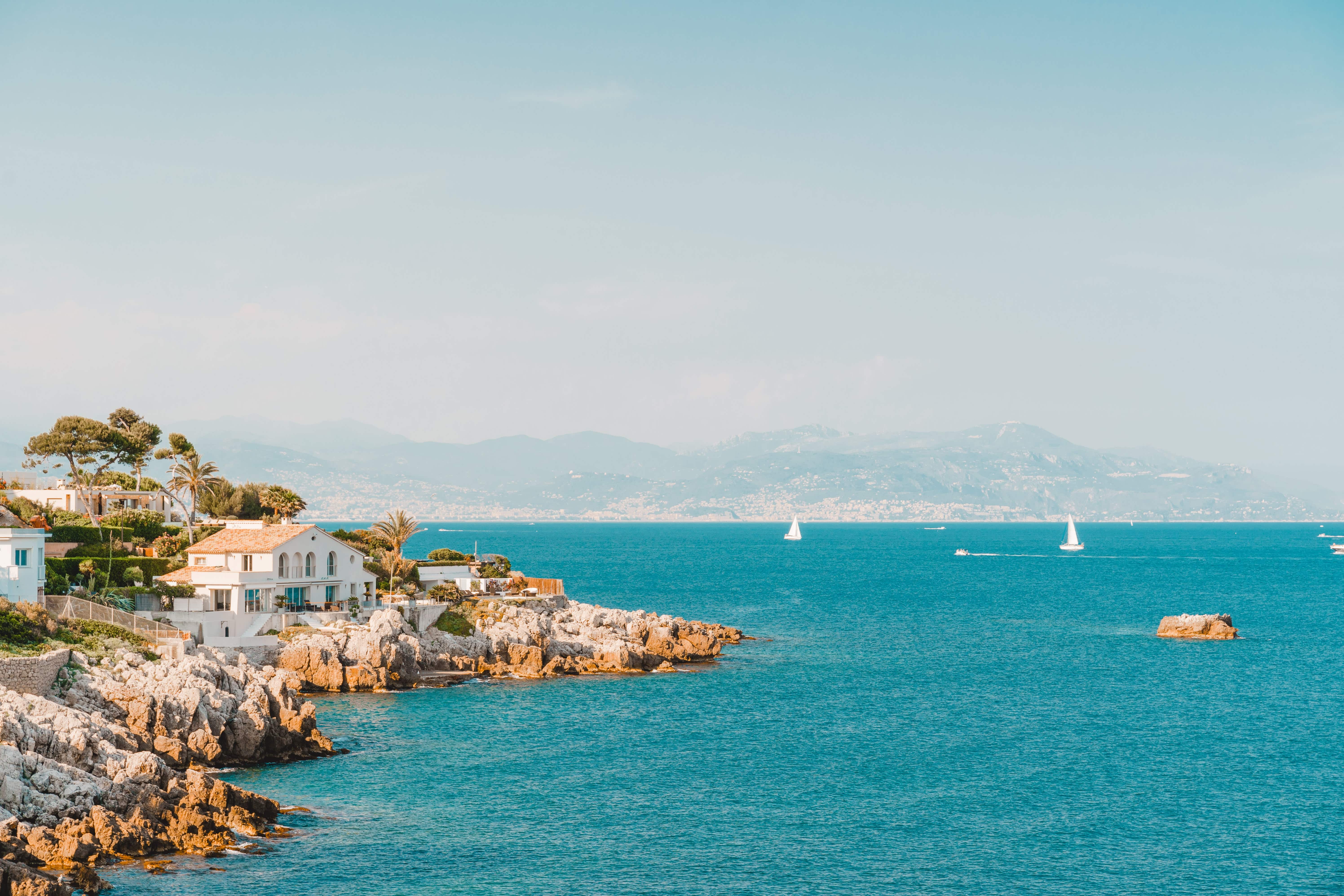 view of cap d'antibes with mansions and boats